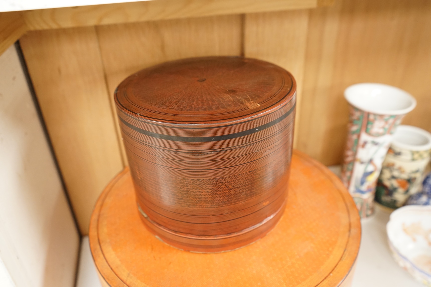 Two 19th century Burmese lacquered cylindrical boxes, largest 27cm in diameter